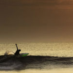 Surfer-making-a-perfect-turn-in-a-beautiful-sunset-in-northern-Peru,-South-America.-(1)